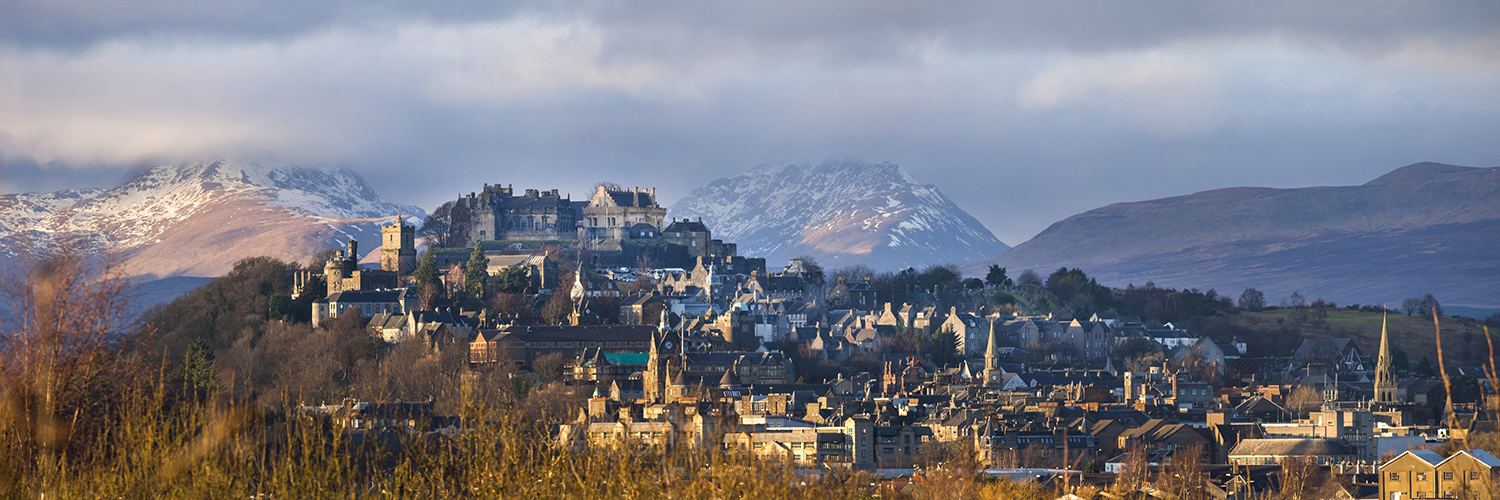 Panoramic view of the Stirling Castle and the old town with the Highlands at the background